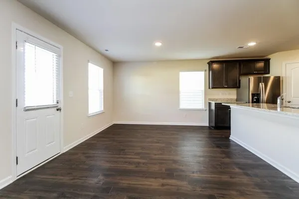 a view of kitchen with wooden floor and electronic appliances