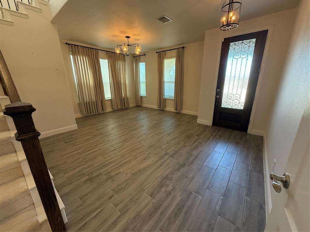 5212 Troupe Road McKinney, TX 75071 - Photo 3 of 38 Entry foyer featuring wood-look tile flooring and a decorative glass-paneled front door