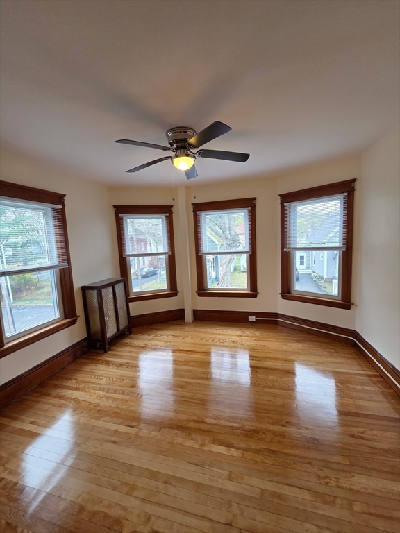 15 Berkmans Street, Unit 2 Worcester, MA 01602 - Photo 3 of 13 a view of an empty room with window and wooden floor