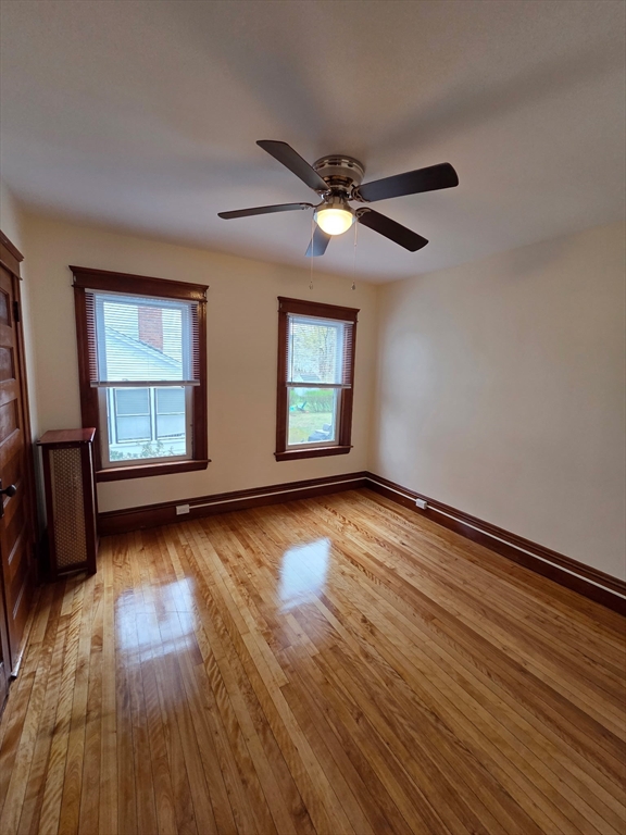 15 Berkmans Street, Unit 2 Worcester, MA 01602 - Photo 4 of 13 a view of an empty room with wooden floor and a window