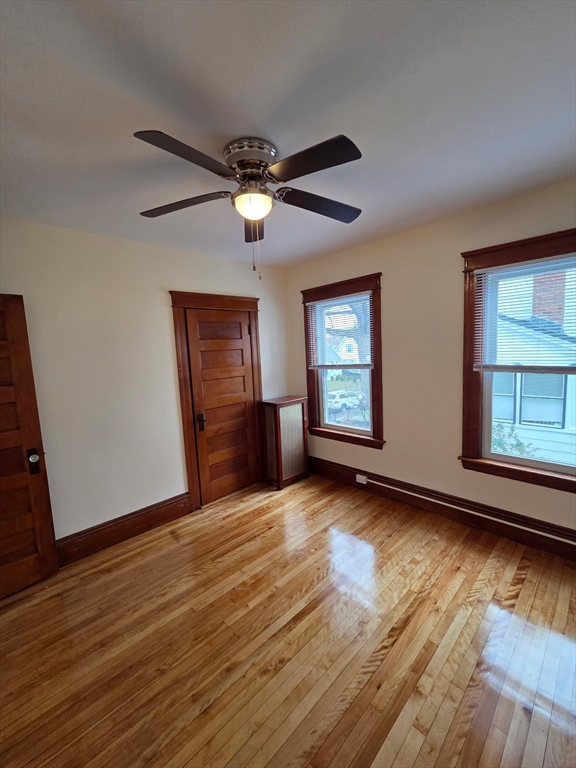 15 Berkmans Street, Unit 2 Worcester, MA 01602 - Photo 5 of 13 a view of empty room with wooden floor and fan