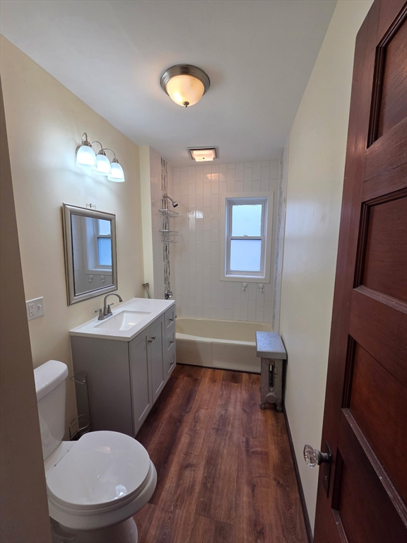 15 Berkmans Street, Unit 2 Worcester, MA 01602 - Photo 9 of 13 a bathroom with a granite countertop toilet a sink and mirror