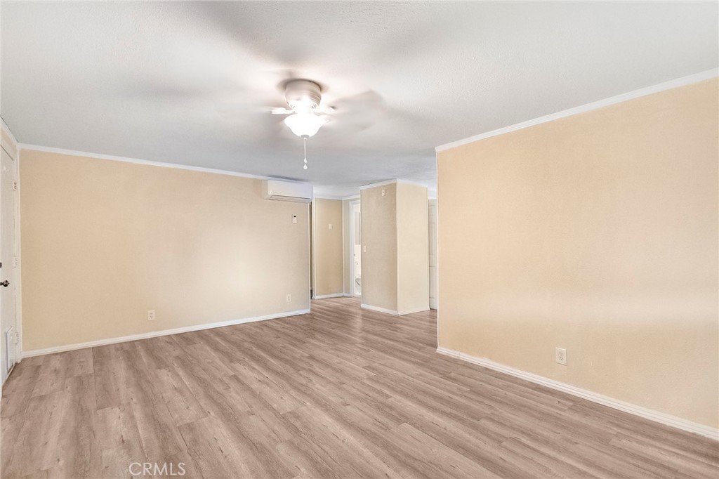 3156 Esplanade, Unit 292 Chico, CA 95973 - Photo 13 of 32 a view of an empty room with wooden floor and a ceiling fan