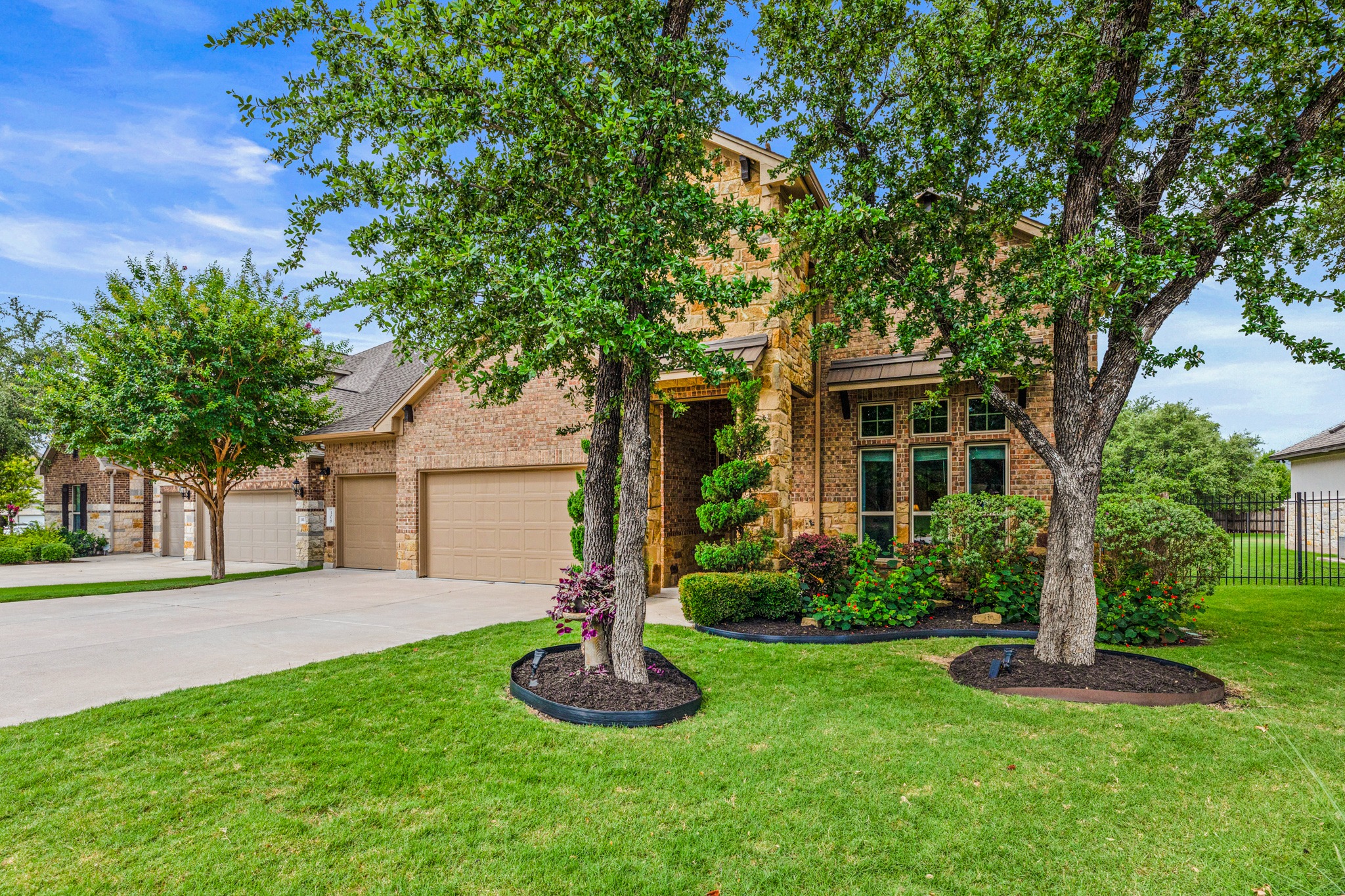 108 Redtail Lane Leander, TX 78641 - Photo 1 of 39 3 car garage, landscaping, a pristine lawn, and accent lighting, including soffit lighting.