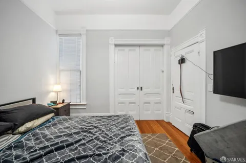 a bedroom with a bed and flat screen tv