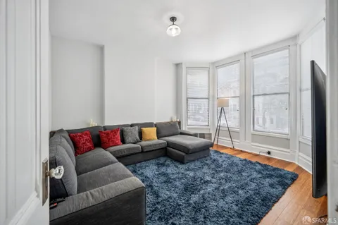 a living room with furniture and a rug