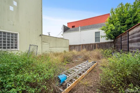 a backyard of a house with lots of green space and chair