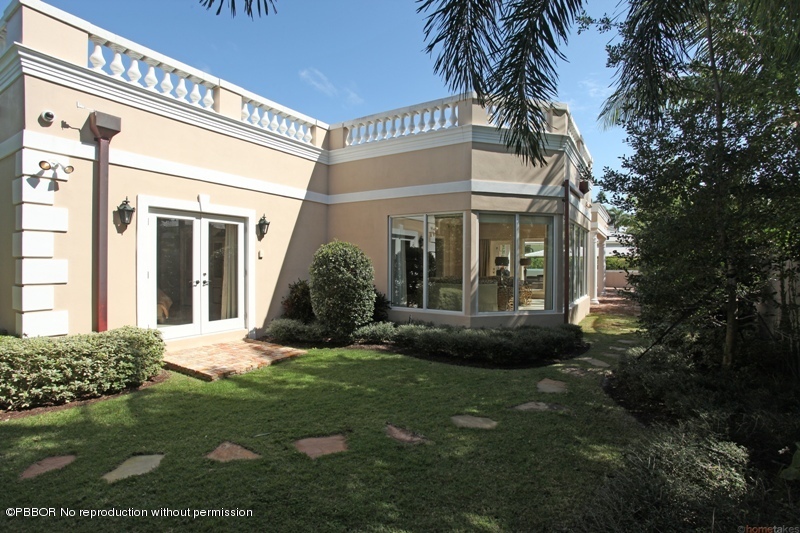 300 Dunbar Road Palm Beach, FL 33480 - Photo 13 of 14 a view of a house with a small yard and plants
