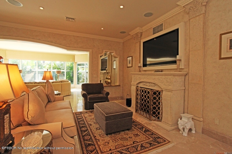 300 Dunbar Road Palm Beach, FL 33480 - Photo 3 of 14 a living room with furniture a flat screen tv and a floor to ceiling window