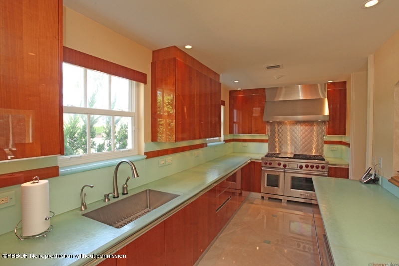 300 Dunbar Road Palm Beach, FL 33480 - Photo 6 of 14 a kitchen with a large window cabinets and stainless steel appliances