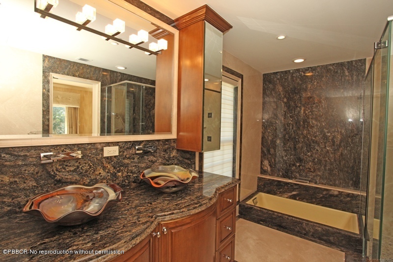 300 Dunbar Road Palm Beach, FL 33480 - Photo 8 of 14 a bathroom with a granite countertop sink and a mirror
