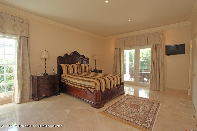 300 Dunbar Road Palm Beach, FL 33480 - Photo 9 of 14 a spacious bedroom with a bed and glass door