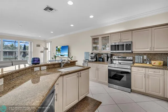 a kitchen with granite countertop a sink and a window