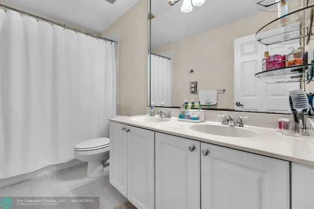 a bathroom with a tub a sink and mirrors