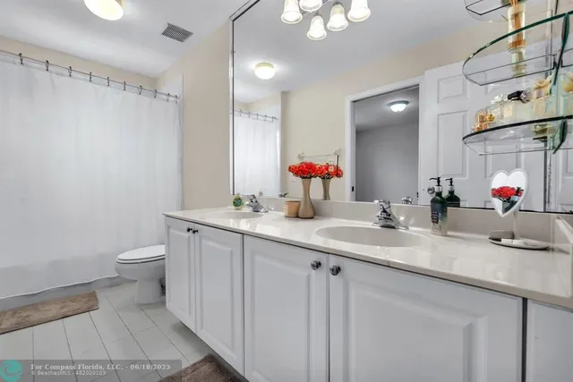 a bedroom with furniture and a large window