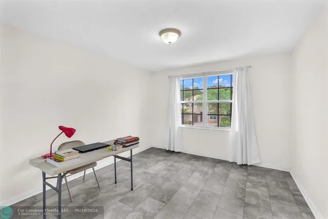 a view of a house with a yard and a patio