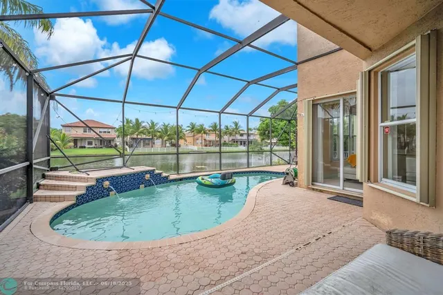 a view of a house with a yard and a fountain