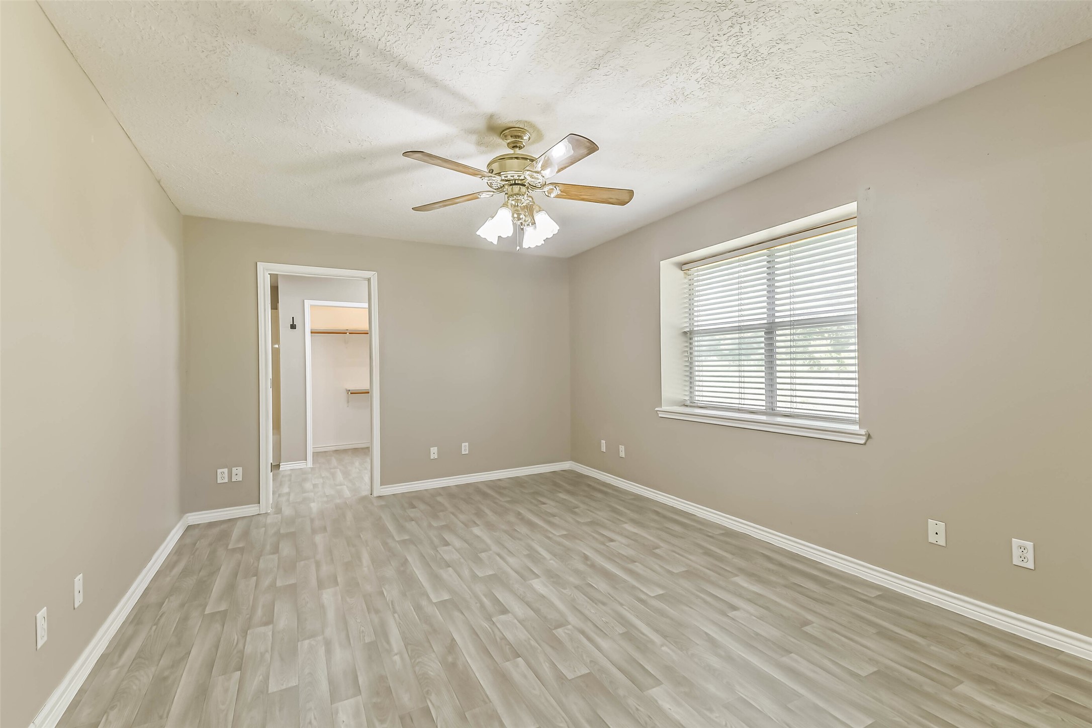 4869 Fm 2518 Cleveland, TX 77327 - Photo 29 of 41 an empty room with windows and a ceiling fan