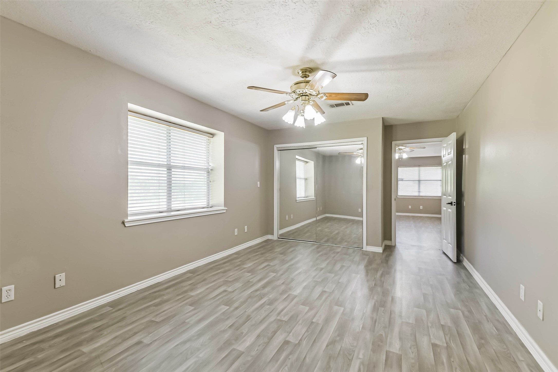 4869 Fm 2518 Cleveland, TX 77327 - Photo 30 of 41 wooden floor in an empty room with a window