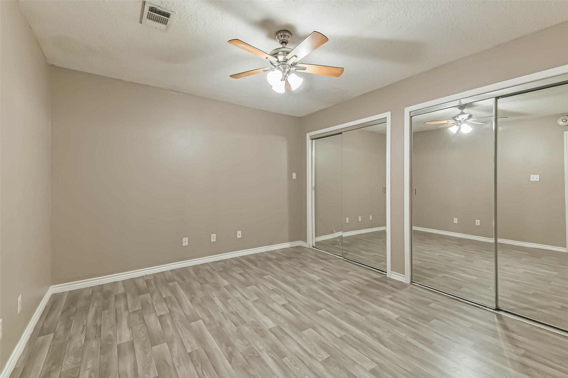 4869 Fm 2518 Cleveland, TX 77327 - Photo 33 of 41 a view of an empty room with cabinet and a ceiling fan
