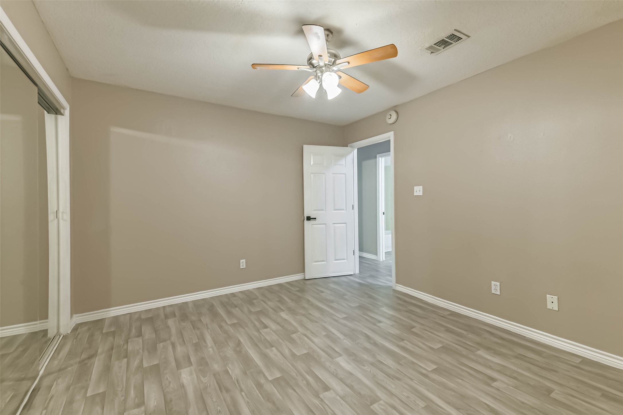 4869 Fm 2518 Cleveland, TX 77327 - Photo 34 of 41 wooden floor in an empty room with a window