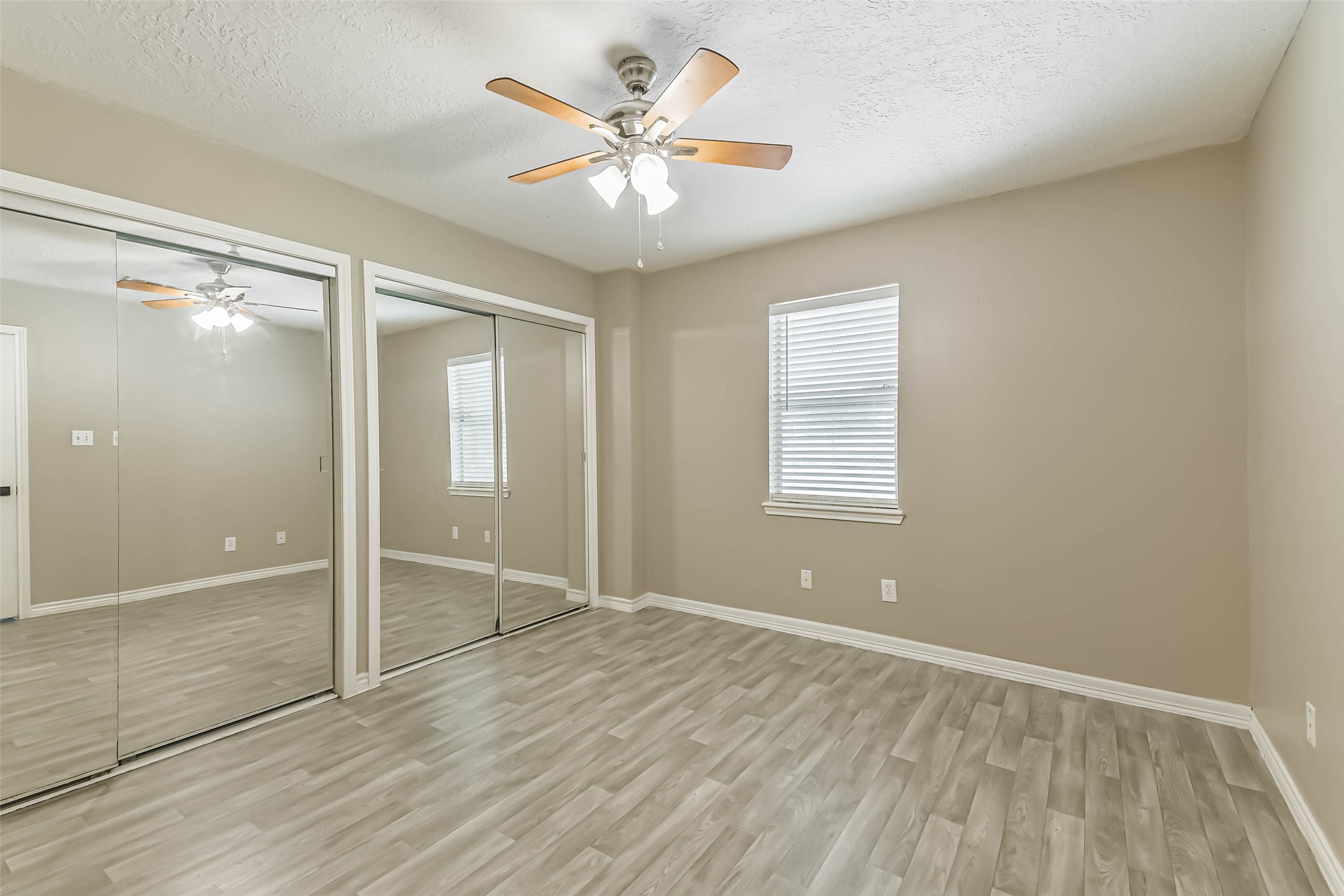 4869 Fm 2518 Cleveland, TX 77327 - Photo 37 of 41 an empty room with closet and a ceiling fan