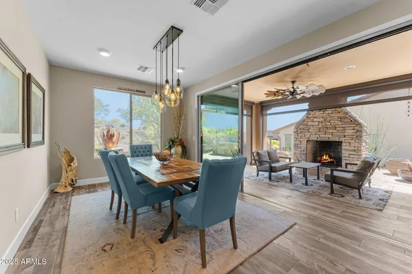 a kitchen with kitchen island stainless steel appliances a stove a table and chairs