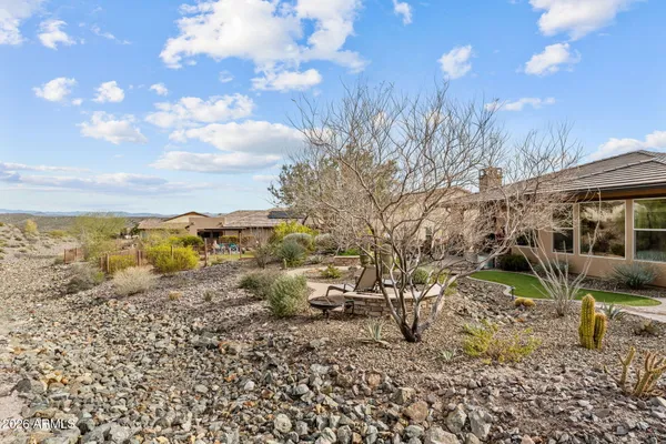 a view of a swimming pool with a bench and trees