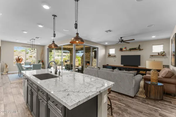 a kitchen with sink table and chairs