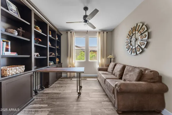 a living room with furniture a rug and a window