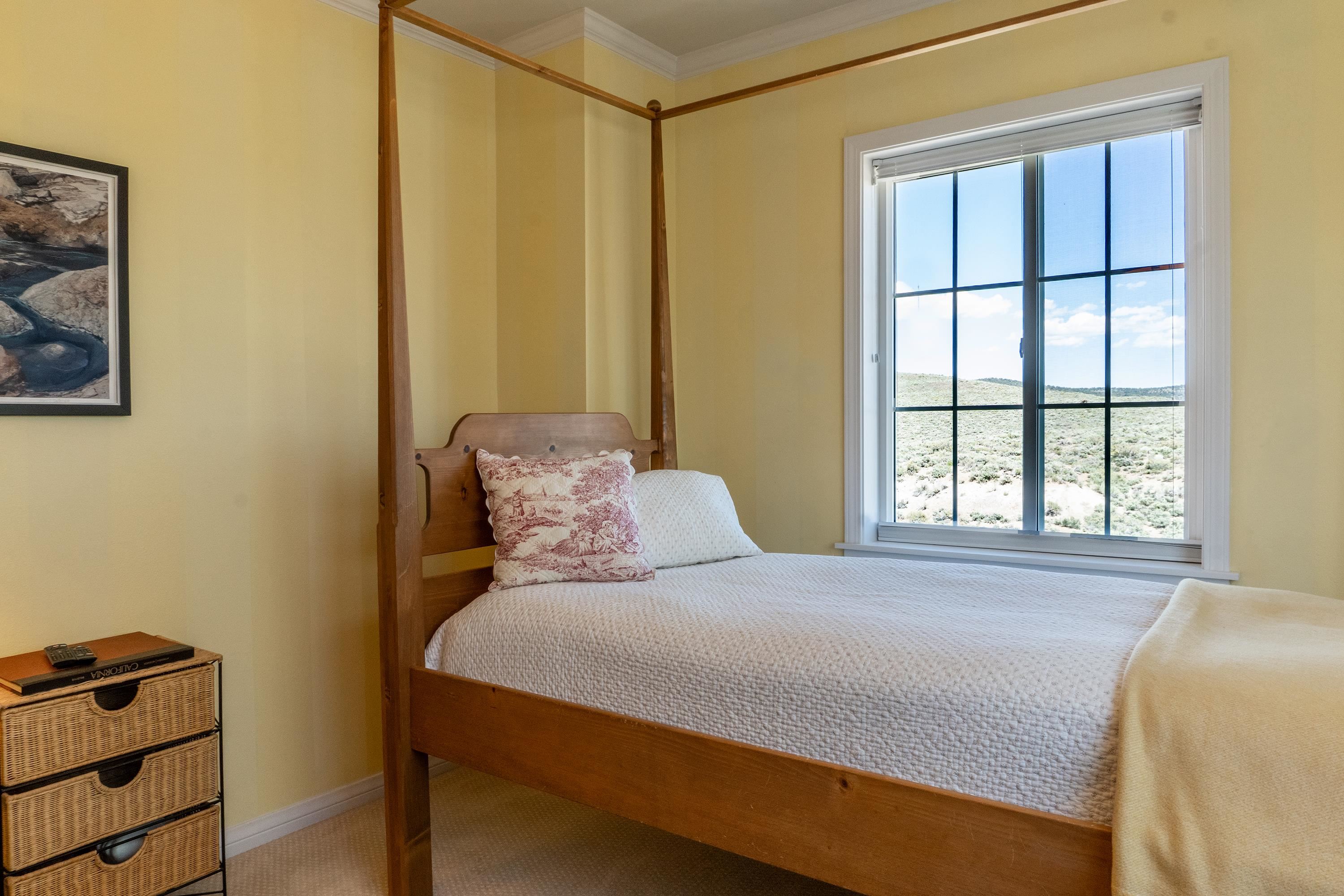 416 Wilson Creek Road Lee Vining, CA 93541 - Photo 38 of 64 a bedroom with a bed and a window