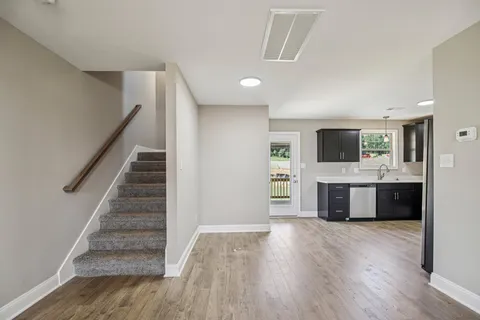 a kitchen with stainless steel appliances and wooden floor