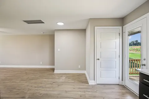 a kitchen with stainless steel appliances granite countertop a refrigerator a sink a stove and oven