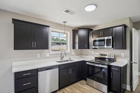 an empty room with window and ceiling fan