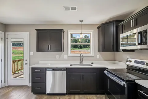 a bathroom with a shower sink vanity and mirror