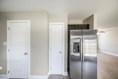 a bathroom with a granite countertop toilet a sink and a mirror