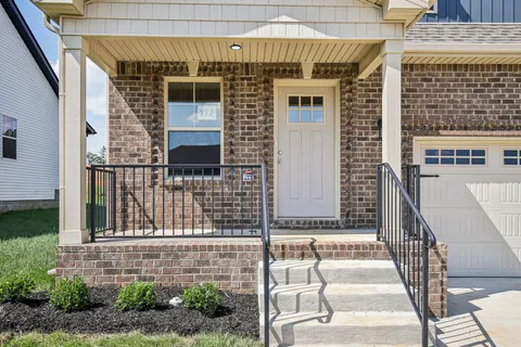 a front view of a house with large windows