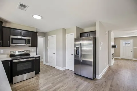 a bathroom with a sink a mirror and a window