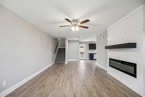 a view of kitchen with microwave and refrigerator