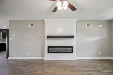 a large kitchen with stainless steel appliances granite countertop a refrigerator and a sink