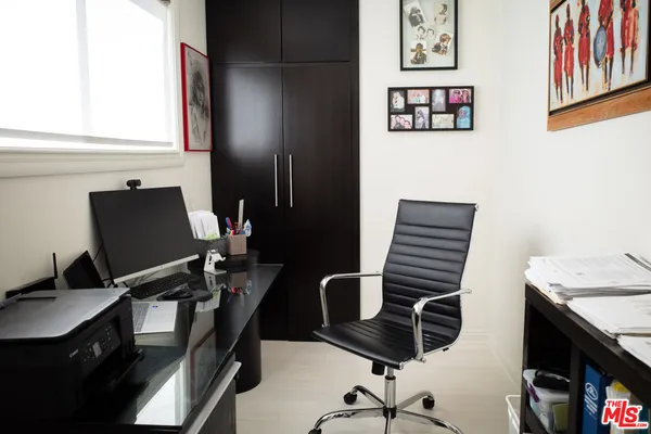 a view of a workspace with furniture and lamp
