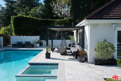 a view of a patio with chairs and plants