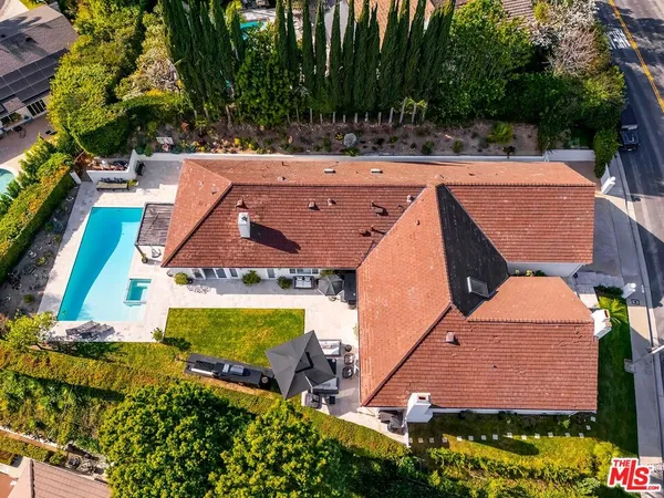 an aerial view of house with yard swimming pool and outdoor seating