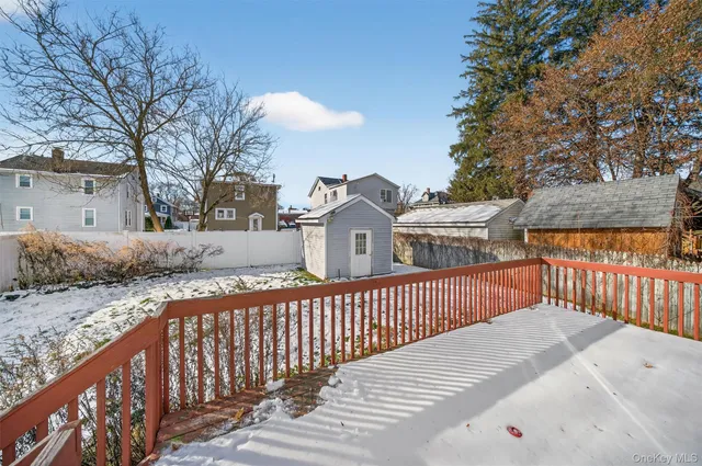 a view of a house with a wooden fence