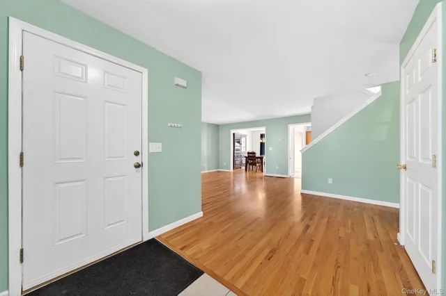 a view of a hallway view with wooden floor and staircase