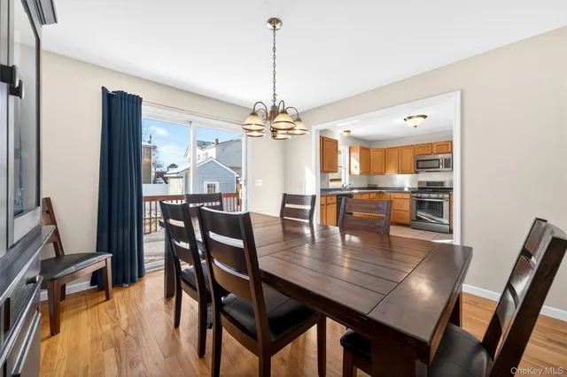 a dining room with furniture a chandelier and wooden floor