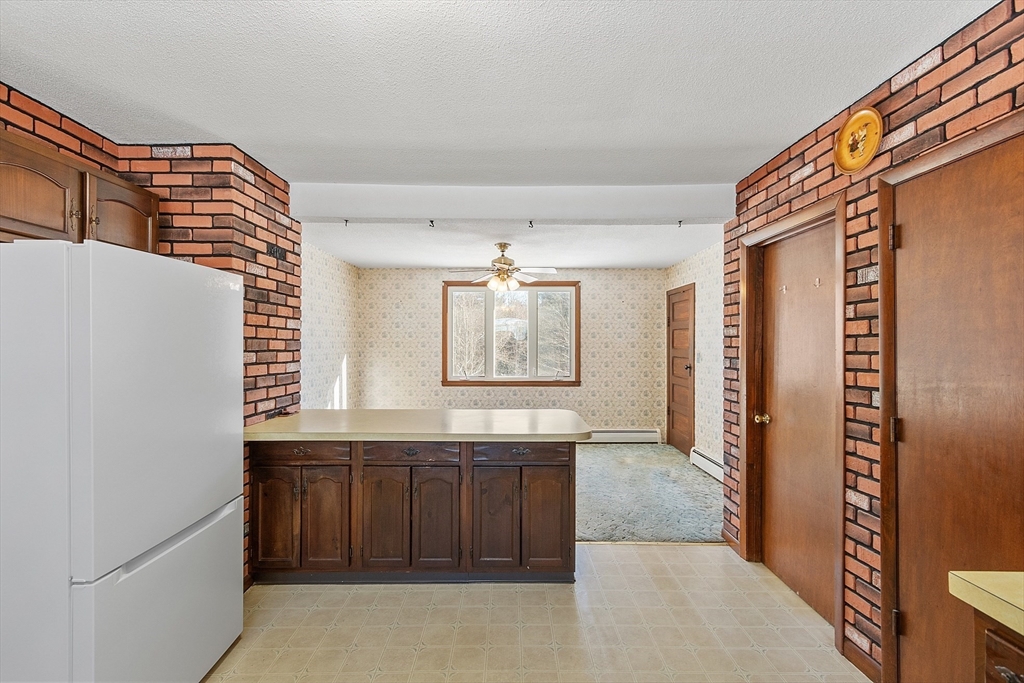 318 Lovewell Street Gardner, MA 01440 - Photo 12 of 42 a bathroom with a granite countertop sink and a mirror