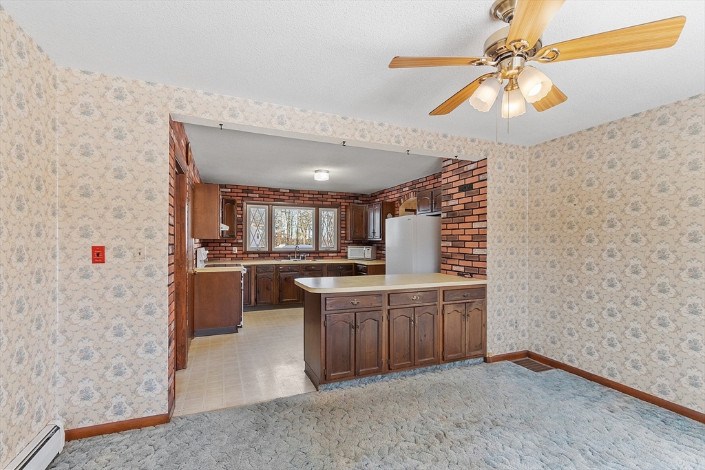 318 Lovewell Street Gardner, MA 01440 - Photo 14 of 42 a kitchen with refrigerator and cabinets