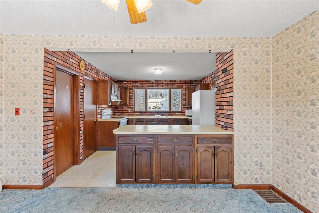 318 Lovewell Street Gardner, MA 01440 - Photo 15 of 42 a kitchen with a sink and cabinets