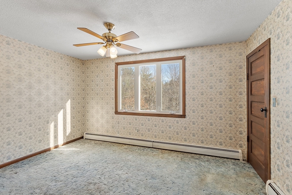318 Lovewell Street Gardner, MA 01440 - Photo 18 of 42 an empty room with windows and fan